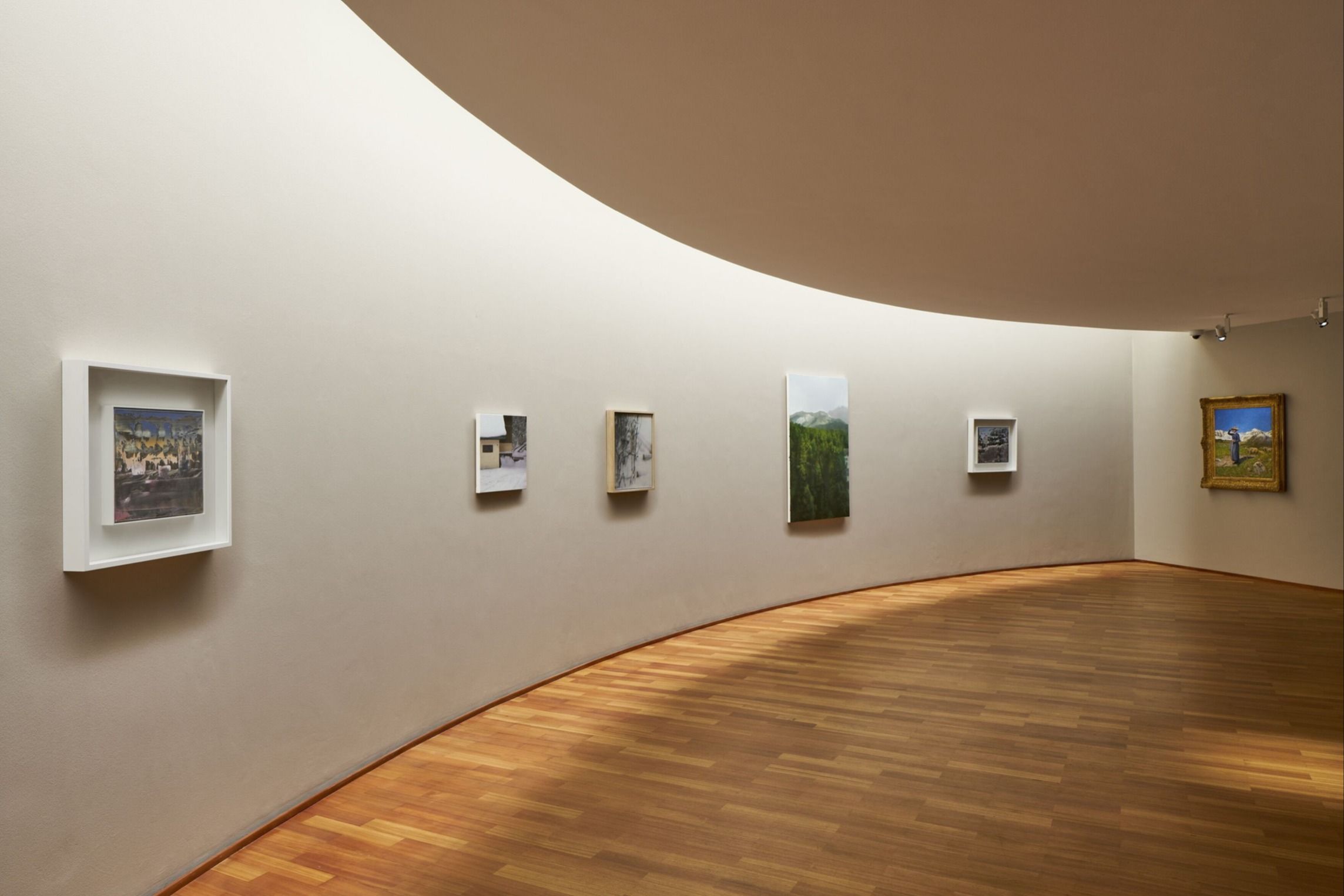 The curved interior wall of an art gallery